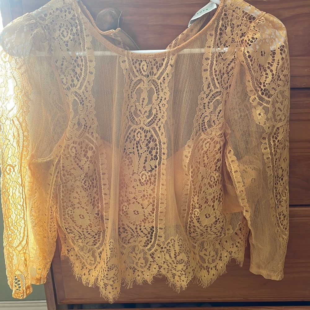 Lace , beautiful top. Wore it for my anniversary. I wore it w a black skirt .